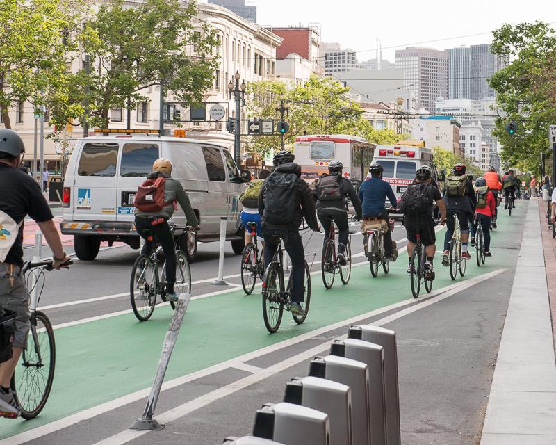 line of cyclists in green bike lane on Market Street