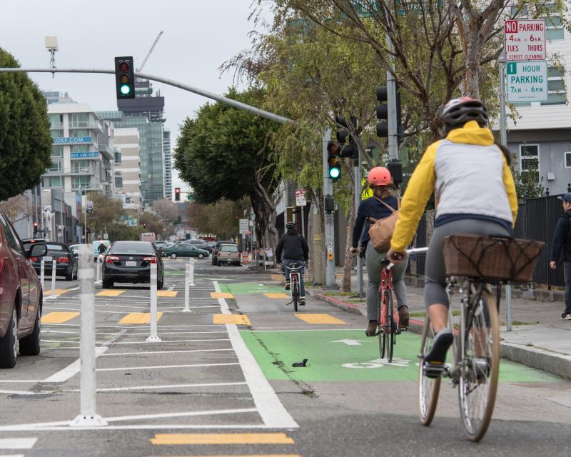 People riding a bike on the newly reconfigured Folsom Street