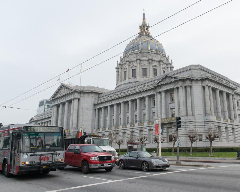 City Hall with Muni bus and traffic on van ness in foreground