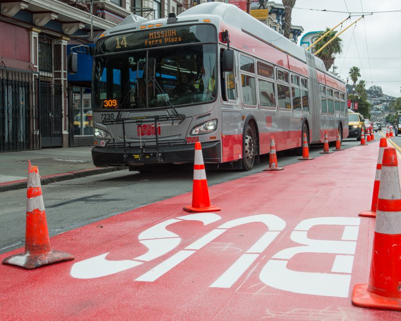 bus driving by red transit lane work on mission street