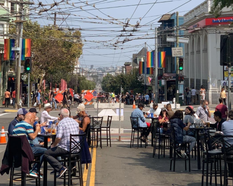 People enjoy the Shared Space at 18th and Castro streets
