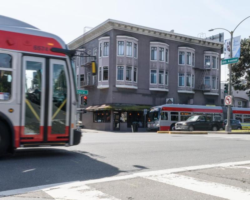 Two buses traveling on Geary Boulevard in the Richmond