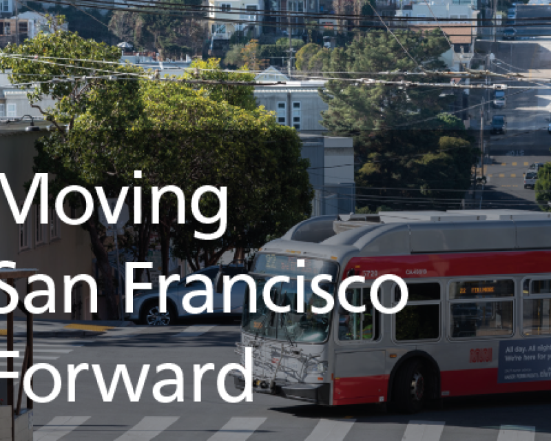 A San Francisco neighborhood with trees and houses lining the streets and a bus making a turn.