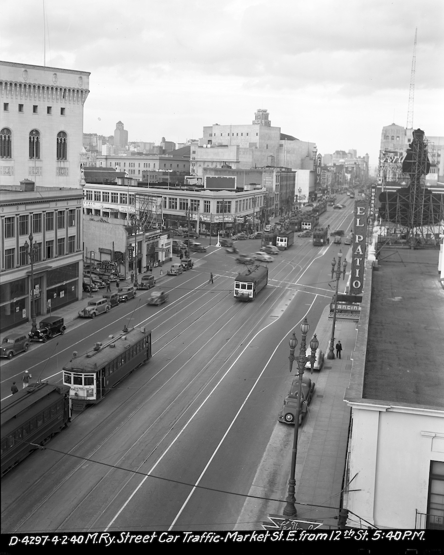 overhead view looking east on market with streetcar and auto traffic buildings and pedestrians