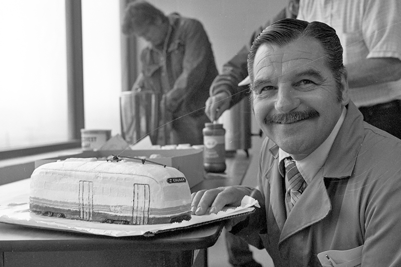 man with streetcar shaped cake