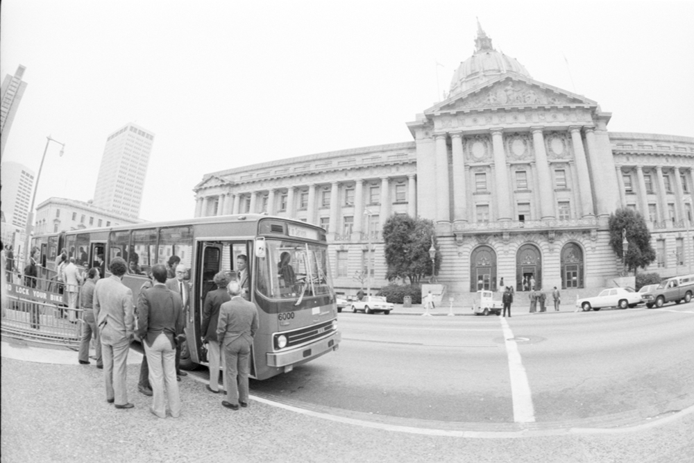 bus and people outside SF City Hall