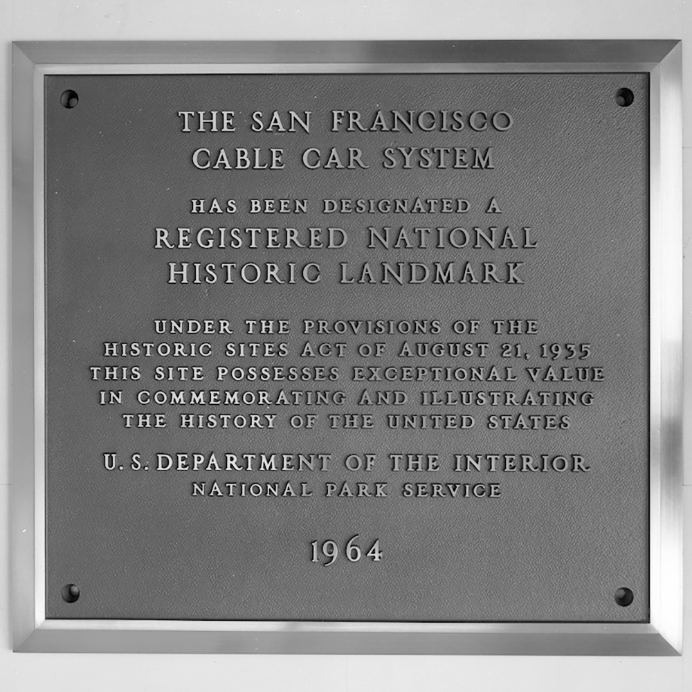 plaque for cable car national landmark status.  Plaque reads: The San Francisco Cable Car System has been designated a Registered National Historic Landmark  Under the provisions of the historic sites act of August 21, 1935, this site possesses exceptional value in commemorating and illustrating the history of the United States. U.S. Department of the Interior, National Park Service, 1964