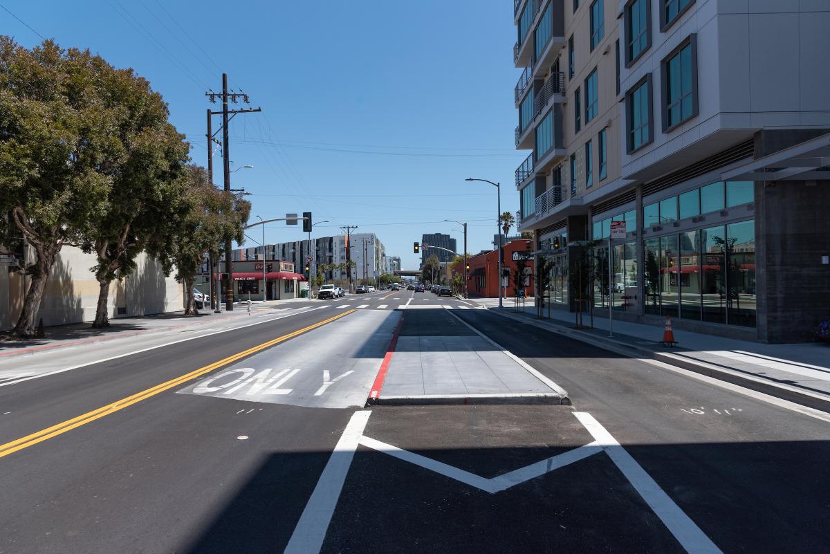 A new center-running transit lane with boarding island on 16th Street. Soon, the lane will be upgraded with red paint, and a shelter and railings will be installed on the island to complete the project.