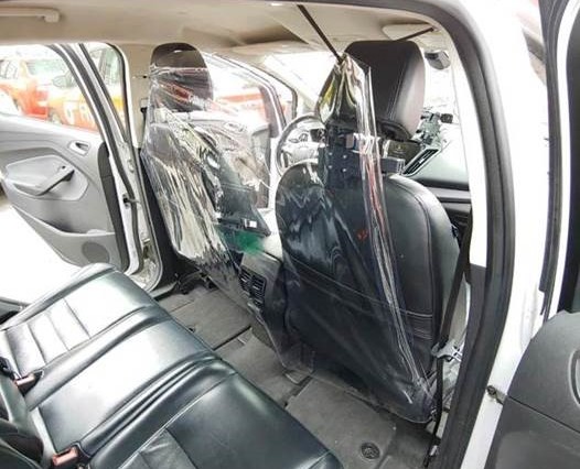 inside of a taxi showing the bubble shield between driver and passenger