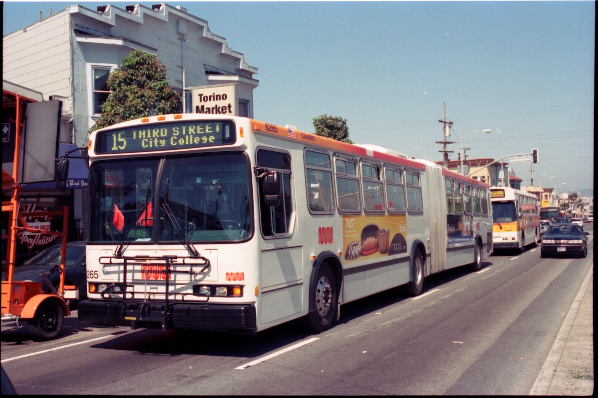 A 15 Third Street coach passes Torino Market at 3rd and Palou on its way out to City College in 2002.