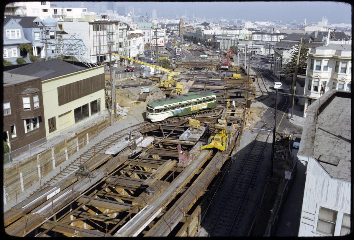 Color image looking east on Market and Collingwood streets showing excavation with streetcar passing over top of hole in ground