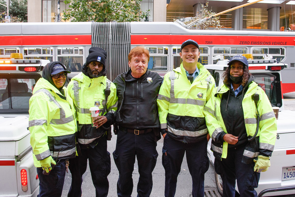 A group of Parking Control Officers and Security Staff from the SFMTA pose for a photo.