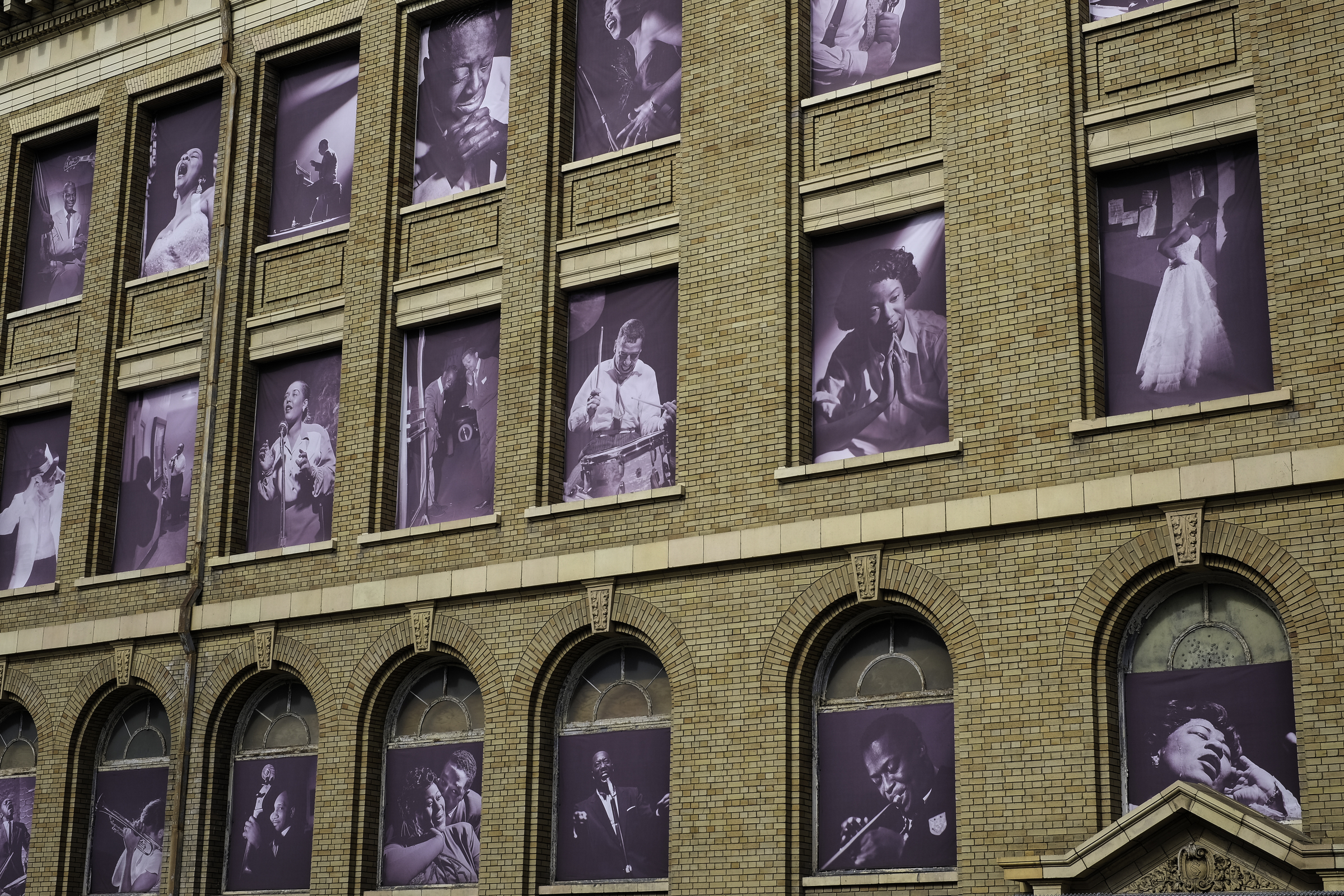 Photos of jazz icons in the windows of the former San Francisco Unified School District building across the street from the SFJAZZ Center