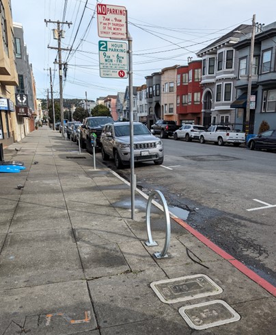 New sidewalk bicycle parking rack on 3rd Avenue at Geary.