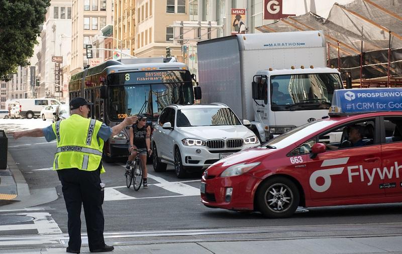 Parking Control Officer directing traffic at California and Kearny streets.