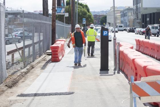 Image of ongoing utility work has been covered over with temporary wooden walkways. 