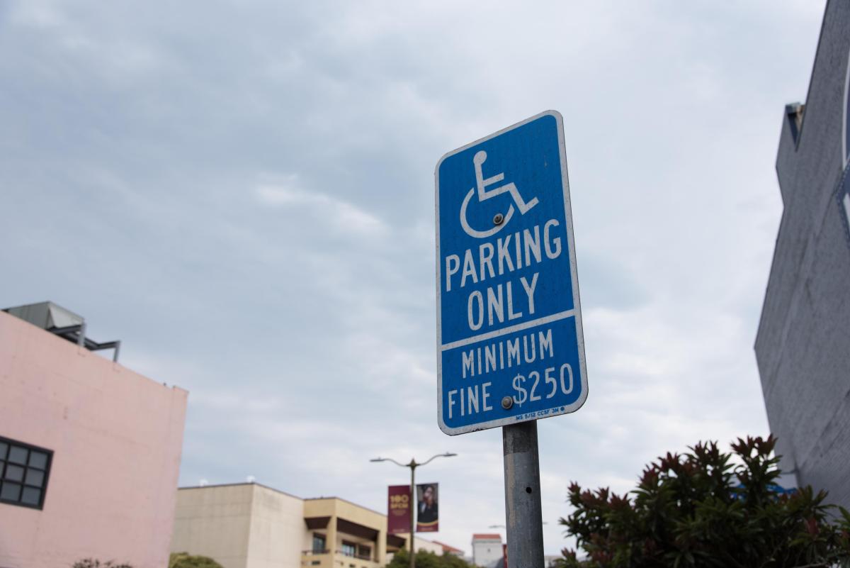 Accessible Parking sign with sky and clouds in background