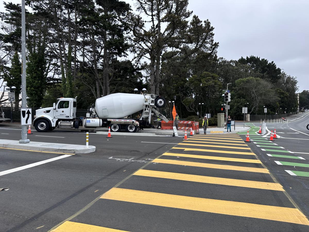 concrete mixer truck pouring concrete for new curb at the intersection of Winston and Lake Merced