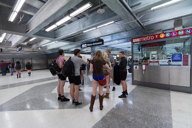 Participants in No Pants Subway Ride stand in Powell Station Muni Metro station wearing only underwear and shoes.
