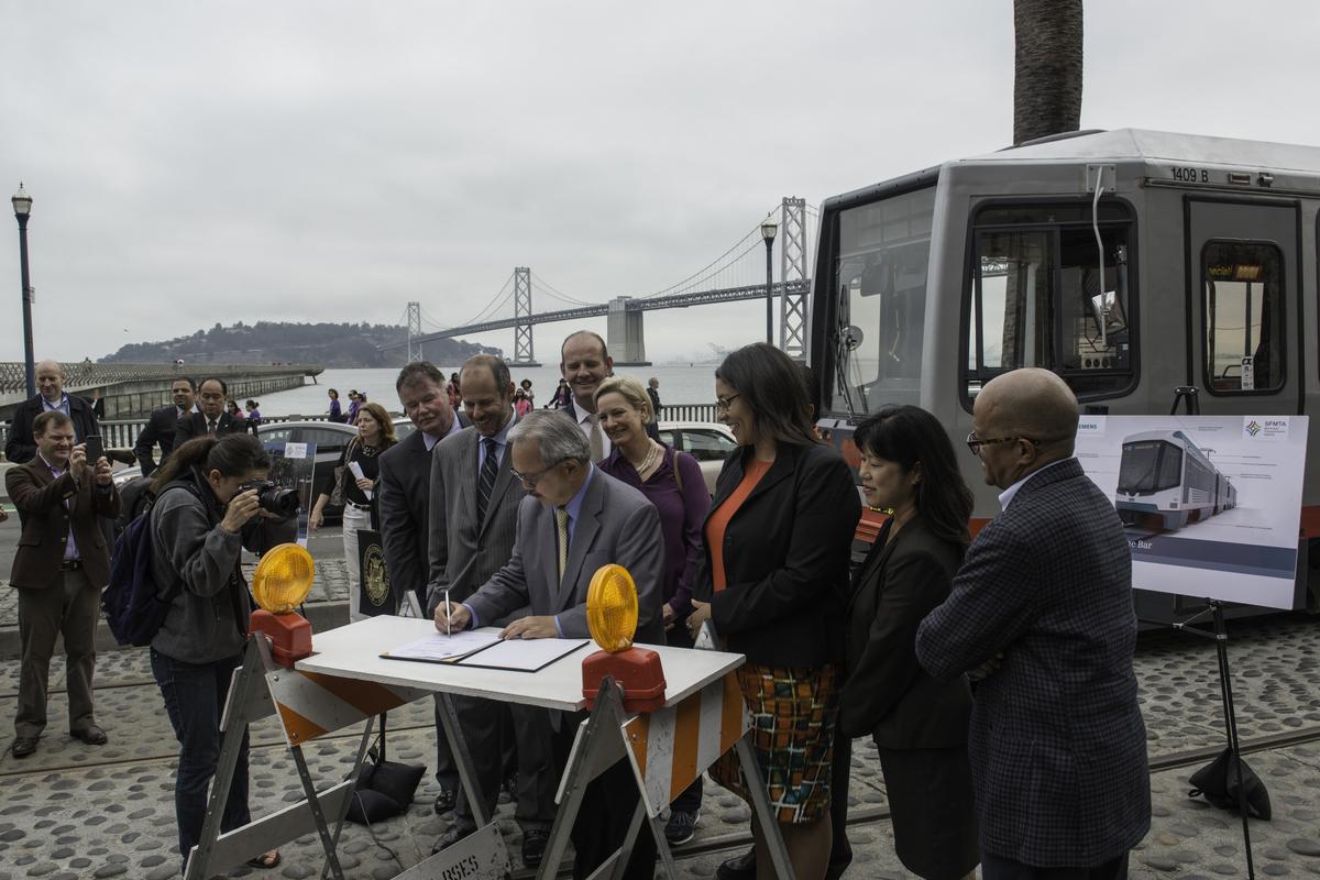 Mayor Lee signs LRV procurement contract at waterfront ceremony with Bay Bridge in background