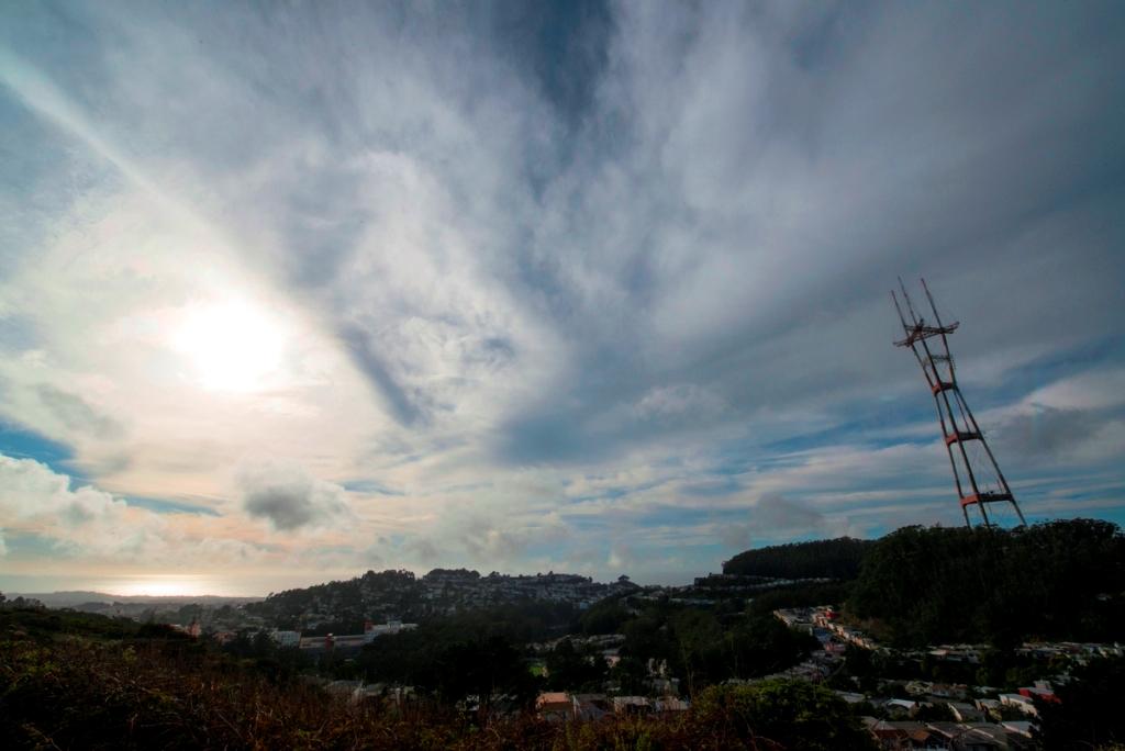 Sutro Tower and San Francisco cityscape viewed from Twin Peaks on a cloudy day.