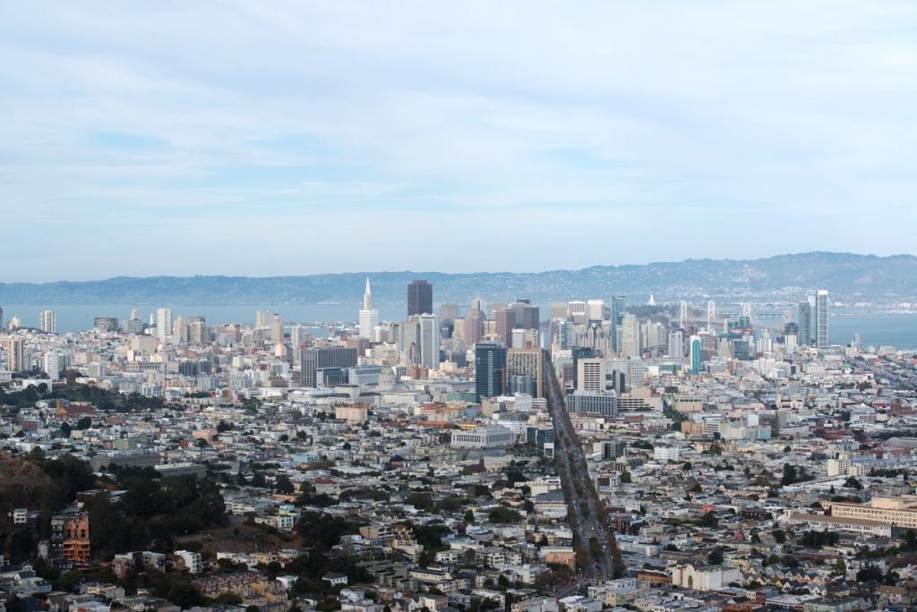 San Francisco skyline viewed from Twin Peaks, with downtown towers, bay, and hills in background
