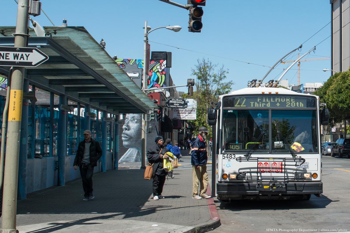Muni bus numbered 22 Fillmore stopped at a street intersection in San Francisco's Western Addition neighborhood.