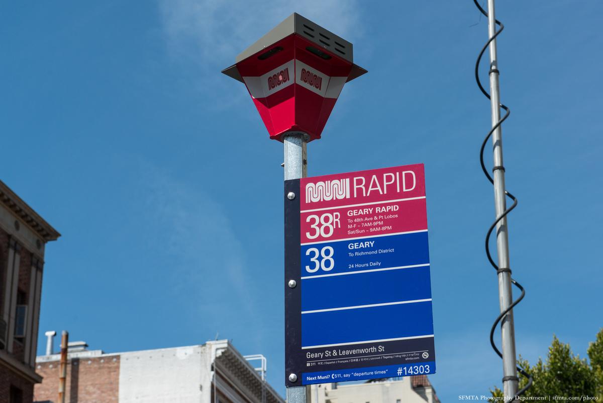 Muni Rapid bus stop sign with red lantern top showing route 38 Geary service information against blue sky.