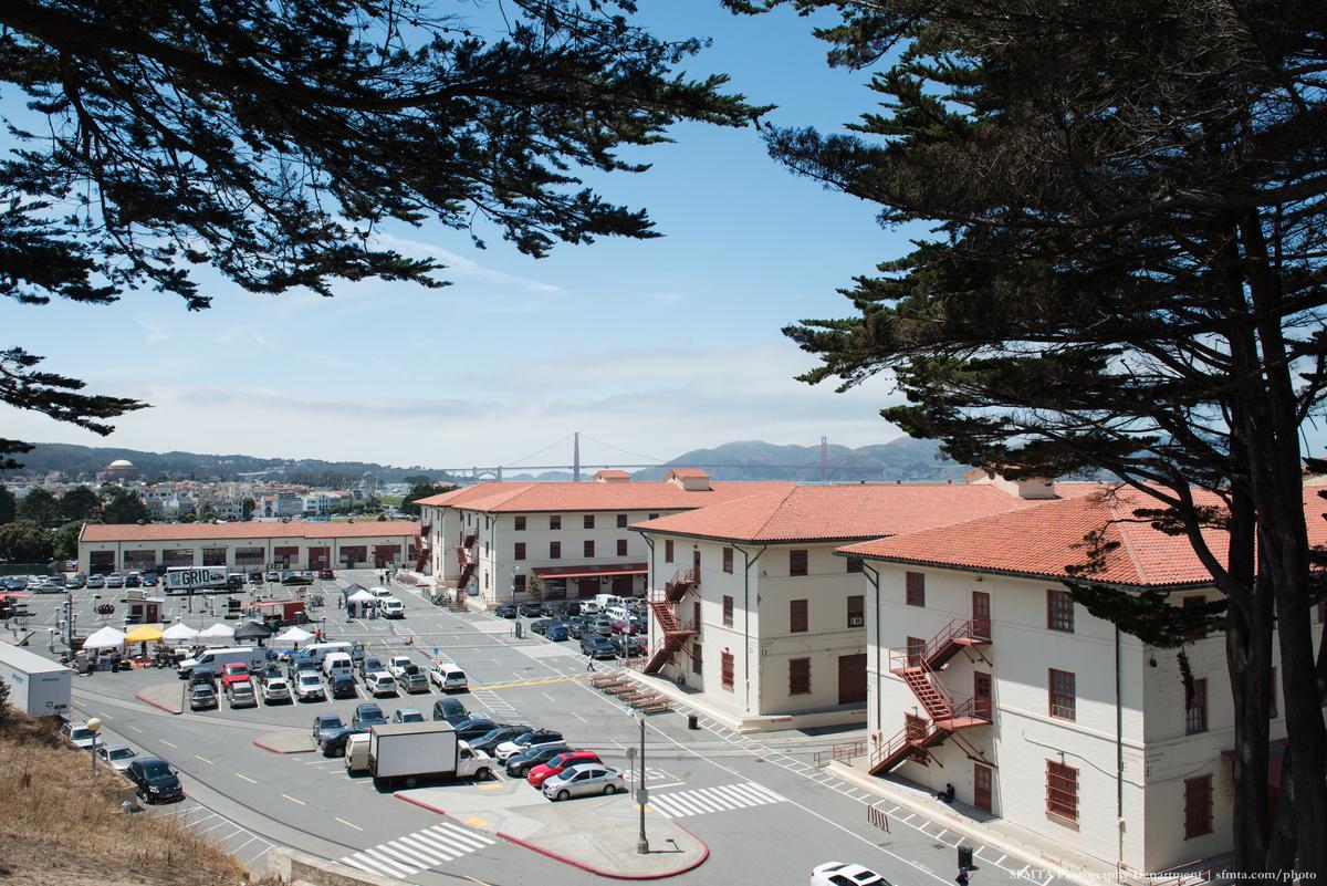 Overhead view of Fort Mason Center parking lot and buildings with bay and hills in background