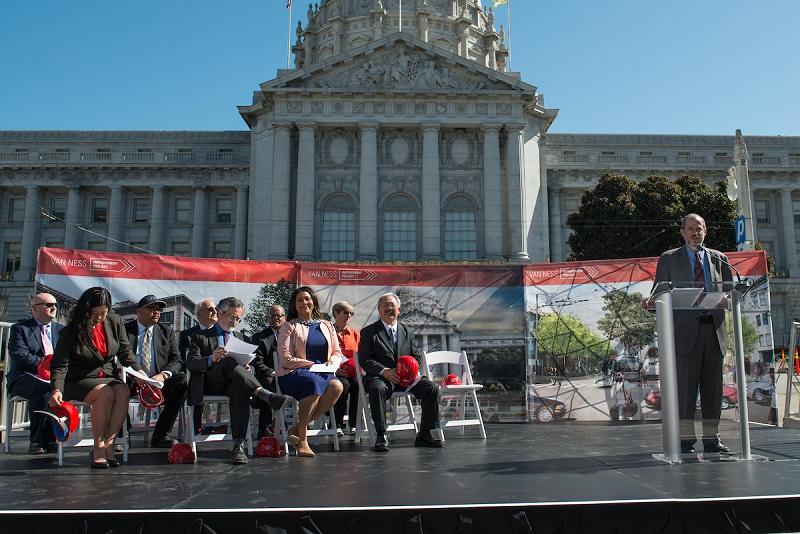 Officials speak at Van Ness Avenue Bus Rapid Transit groundbreaking ceremony in front of San Francisco City Hall.