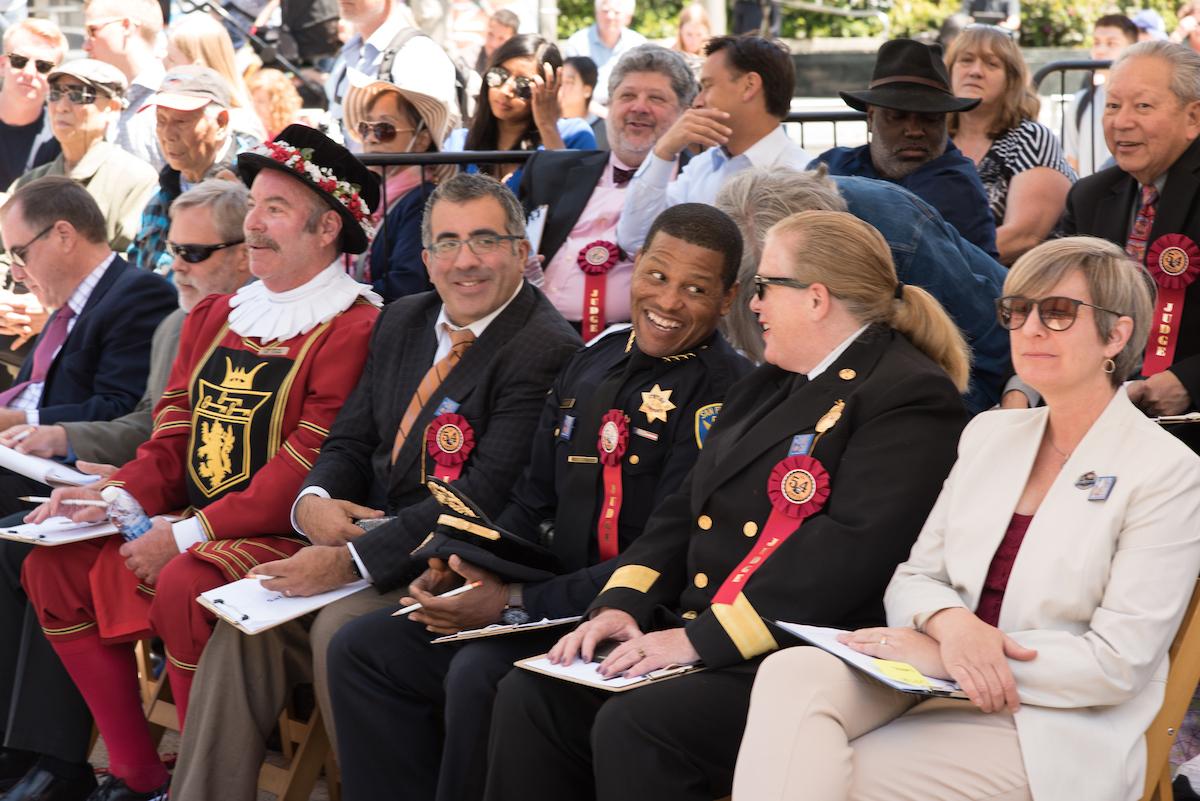 Cable Car Bell Ringing Contest judges seated at event tent in Union Square.
