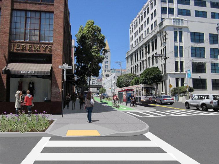 Pedestrian crosswalk on urban street with raised bike lane, transit bus, and brick buildings.