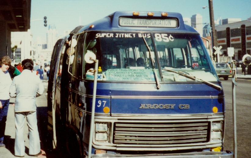 Blue Jitney bus number 97 with open door and passengers boarding on a city street.