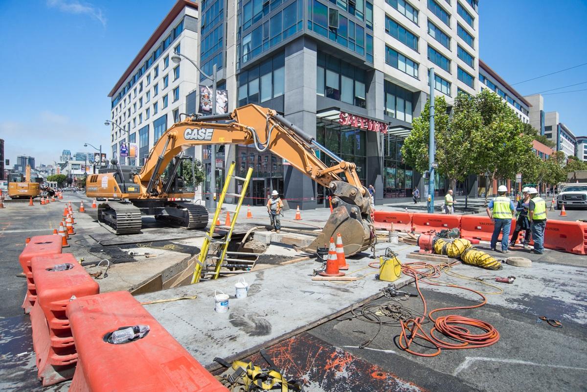 Central Subway construction crew operating excavator at Fourth and King streets in San Francisco.