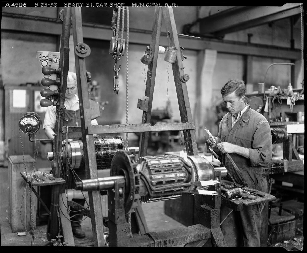 Worker inspecting streetcar motor at Geary Street Car Shop, 1936