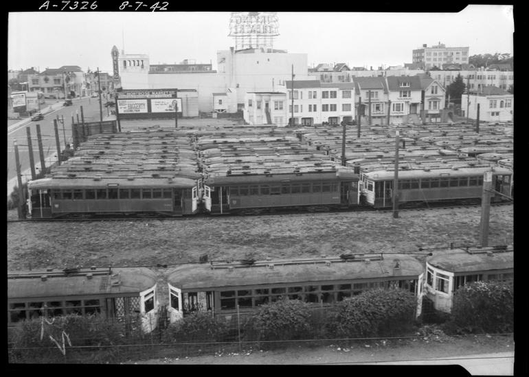Overhead view of streetcar storage lot with multiple vintage electric streetcars in Inner Sunset District, 1942.