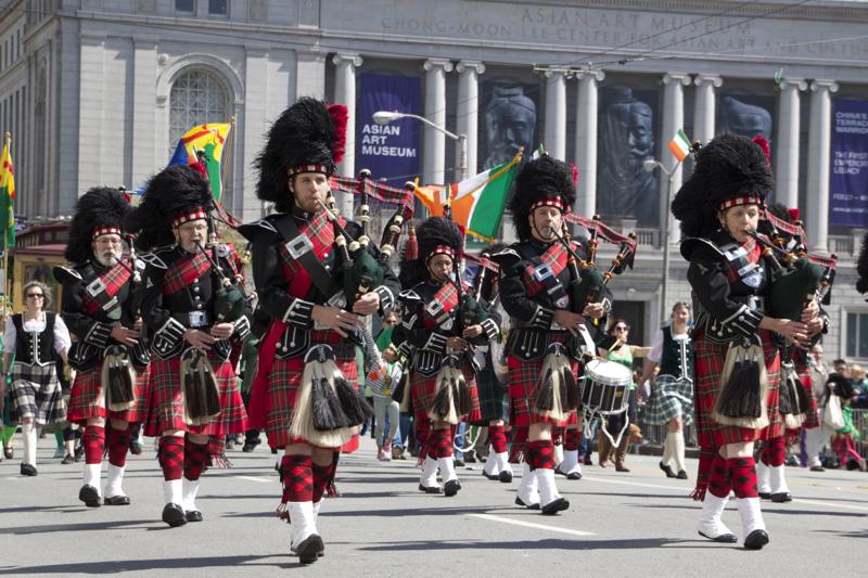 Celtic bagpipe band marching in Civic Center during St. Patrick's Day Parade