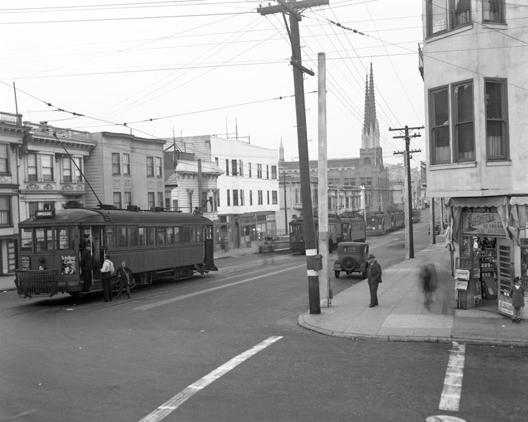 Streetcars at J Church terminal on Church and 30th streets, 1940, with pedestrians and period buildings visible.