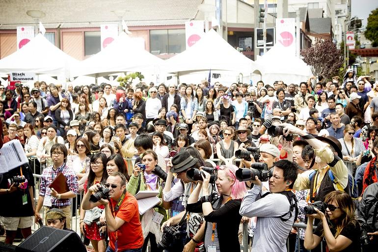 Large crowd gathered under white tents at outdoor J-Pop Summit festival in Japantown.