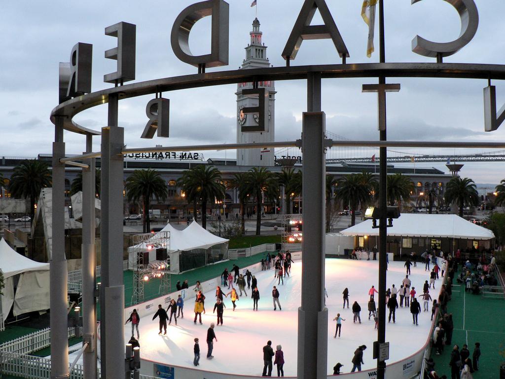 Crowded ice rink at Embarcadero with Ferry Building clock tower in background