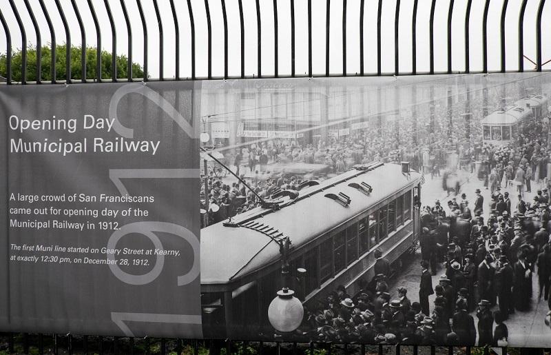 Historical banner showing San Francisco Municipal Railway opening day crowd and early streetcar, December 28, 1912.