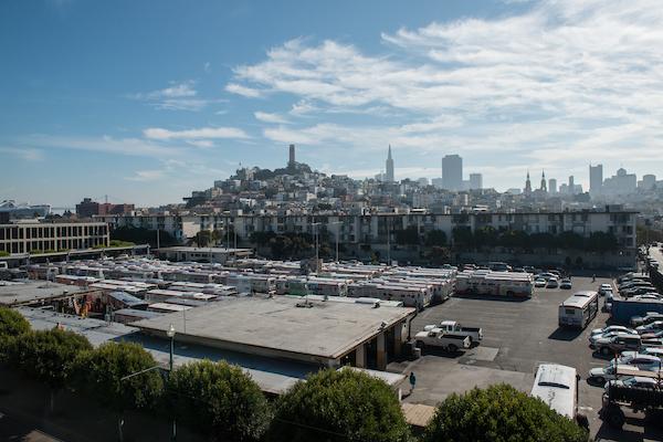 Aerial view of Muni Kirkland Bus Yard with San Francisco skyline in background