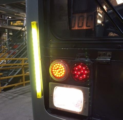 Back of Muni train showing yellow and red LED lights above white destination sign.
