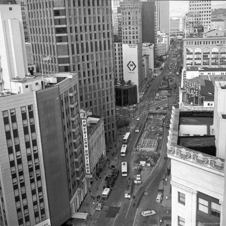 Aerial view of downtown San Francisco street with construction equipment and vehicles, circa 1970.