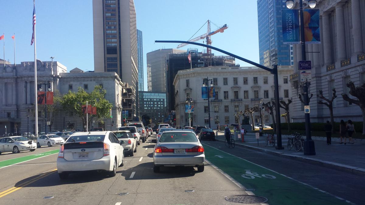 Southbound traffic on Polk Street passes under new traffic signal mast arm near City Hall.