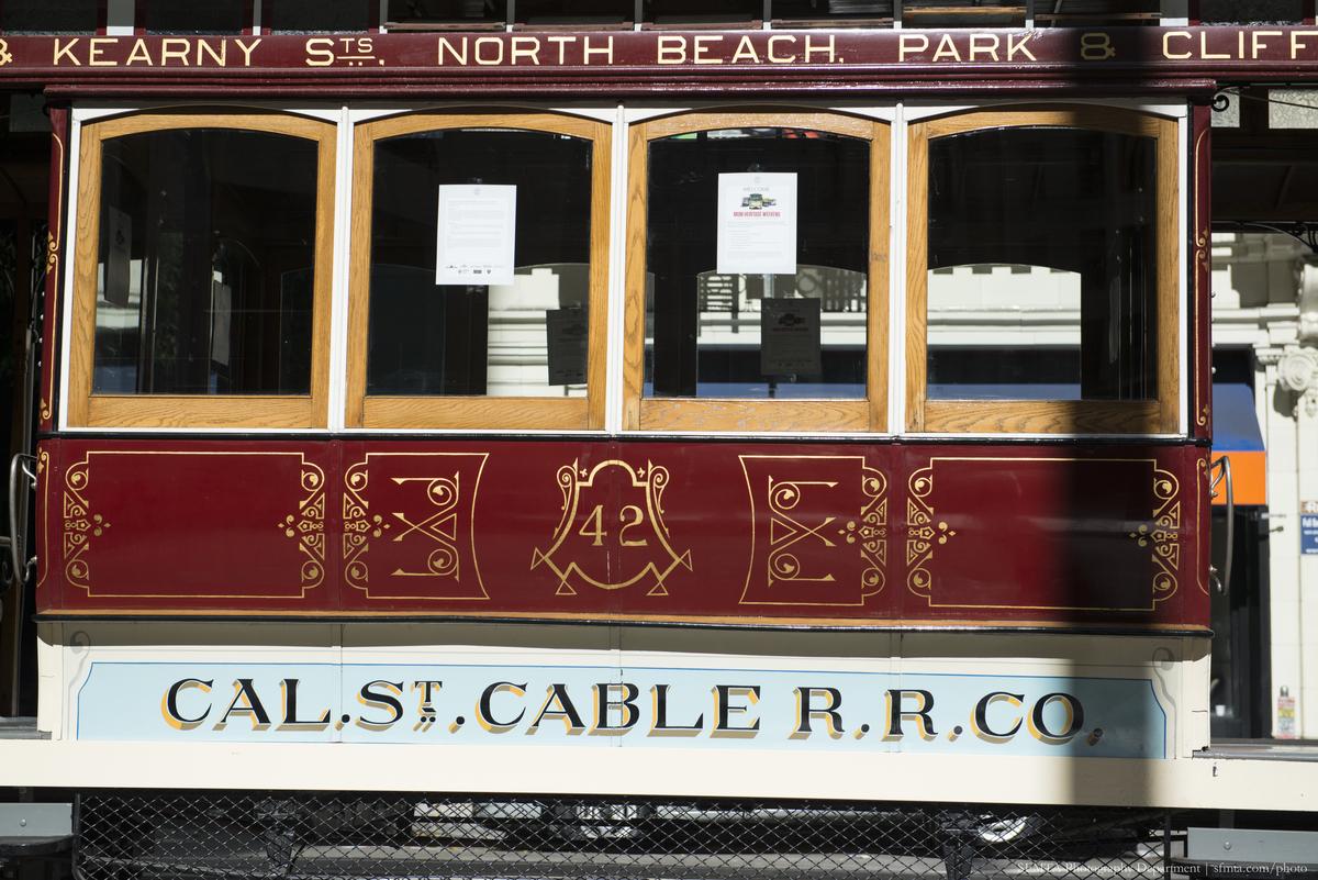 California Cable Car 42 at Kearny Street and North Beach Park, showing ornate red and gold exterior with four windows.