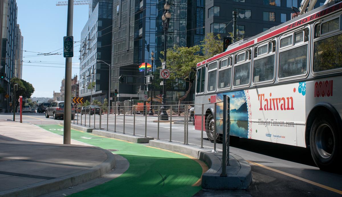 Muni bus on Polk Street with green painted contraflow bike lane in foreground.