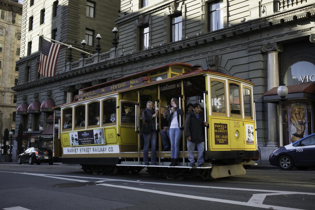 Yellow cable car 15 traveling north on Powell Street past the Westin St. Francis Hotel in Union Square.