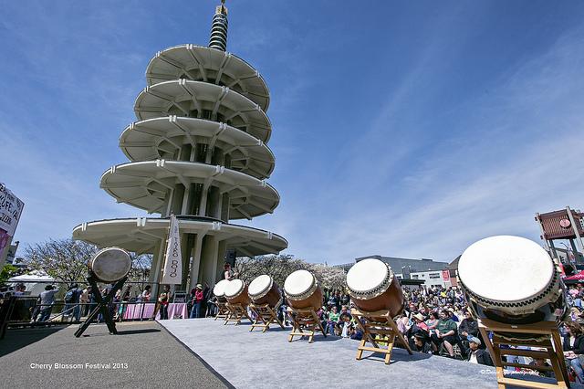 Taiko drummers perform at Japantown Cherry Blossom Festival with Peace Pagoda in background.