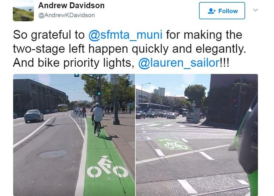 Green painted bike lane with cyclist and traffic signal at Embarcadero intersection.